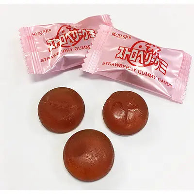 KASUGAI Frutia Strawberry gummies shown outside the packaging, highlighting the individually wrapped pieces and soft, chewy candy texture.