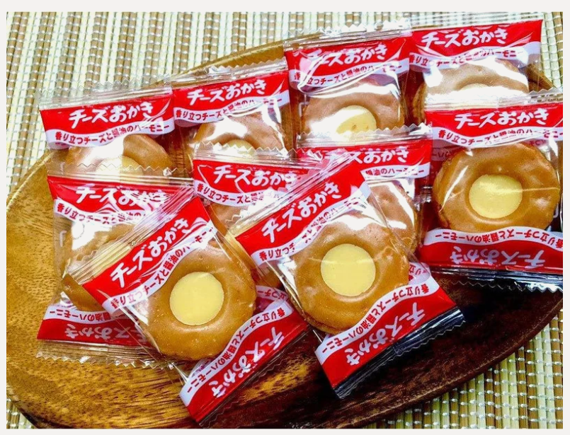 Portrait image of the BOURBON Mini Cheese Okaki Rice Crackers displayed outside the main package, showing the individually wrapped portions alongside the bag.