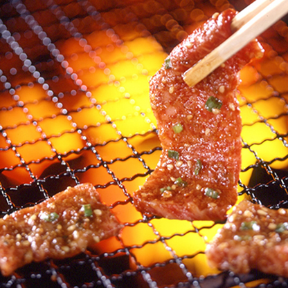 Image of DAISHO Medium Spicy BBQ Sauce being used during grilling, with the sauce applied to meat on a barbecue grill, highlighting its texture and rich flavor in a real cooking setting.