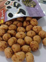 DENROKU Squid Peanut Snack package shown with several coated peanuts placed in front of the bag, highlighting their crunchy squid-seasoned coating against a clean white backdrop.