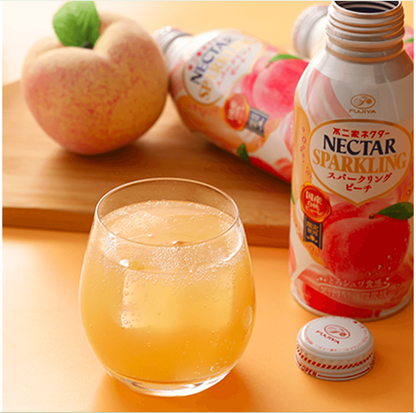 Fujiya Nectar Sparkling White Peach Juice poured out from the metal bottle, showing the drink’s light peach color and sparkling texture.