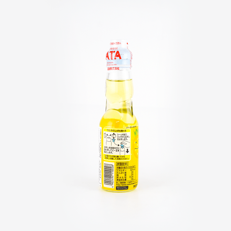 Back view of the HATAKOSEN Pineapple Ramune Soda 6.76 fl oz bottle, displaying product details and label information on the sealed glass bottle against a white background.