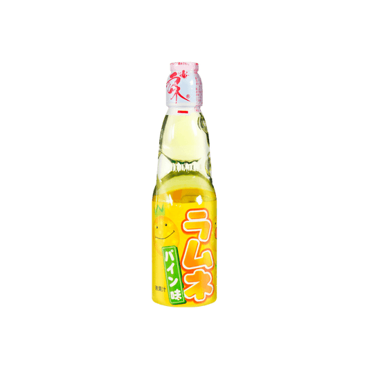 Front view of the HATAKOSEN Pineapple Ramune Soda 6.76 fl oz bottle, showing the classic marble-sealed glass bottle with bright pineapple-themed graphics against a clean white background.
