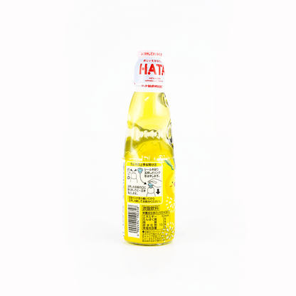 Back view of the HATAKOSEN Yuzu Ramune Soda 6.76 fl oz bottle, displaying product information and label details on the sealed glass bottle over a plain white background.