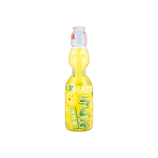 Front view of the HATAKOSEN Yuzu Ramune Soda 6.76 fl oz bottle, showing the sealed marble-stoppered glass bottle with citrus-themed graphics against a clean white background.
