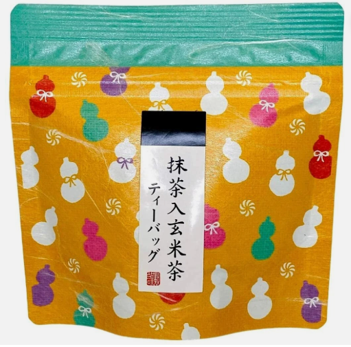 A front-facing portrait image of the OGINO HANAKO genmai matcha tea 100g pouch, shown closed on a white background with clear Japanese graphics and branding visible on the packaging.