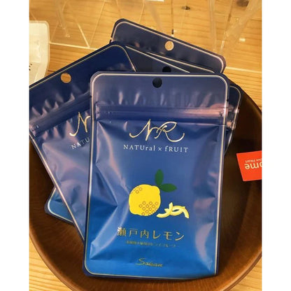 Portrait image of the unopened SOKAN Setouchi Lemon dried fruit package shown alongside four lemon pieces arranged in a bowl on a white background.