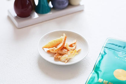 Close-up portrait image of the SOKAN Summer Orange dried fruit slices outside the package, focusing on the detailed texture and natural citrus color.