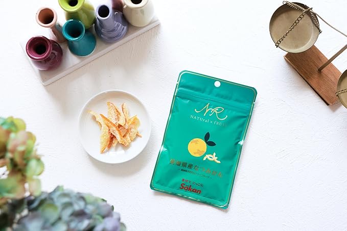 SOKAN Summer Orange dried fruit snack shown with the opened contents beside the unopened package, highlighting the appearance of the dried orange slices.