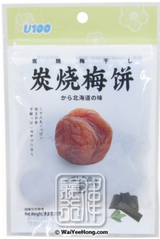 Front-facing view of the U100 Charcoal Roasted Plum Cake 35g in a sealed bag, shown in a portrait orientation on a clean white background.