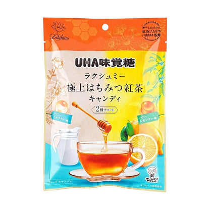 Front-facing portrait image of the UHA Mikakuto Premium Honey Black Tea & Vanilla Milk Tea Candy 2.6 oz bag, sealed and displayed on a clean white background, showing the dual-flavor tea-themed design.