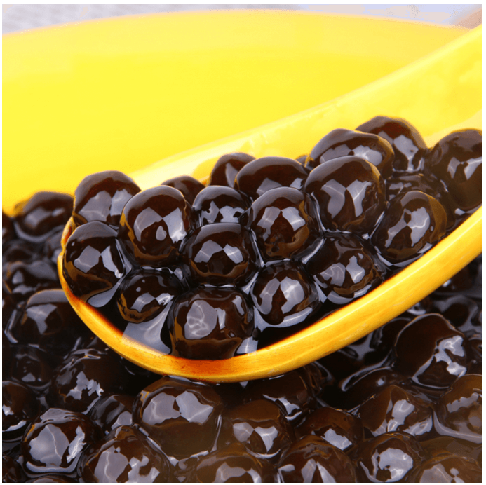 Image of the Wufuyuan Black Sugar tapioca pearls outside the packaging, showcasing the uncooked pearls and their dark, glossy appearance.