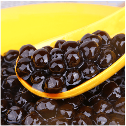 Image of the Wufuyuan Black Sugar tapioca pearls outside the packaging, showcasing the uncooked pearls and their dark, glossy appearance.