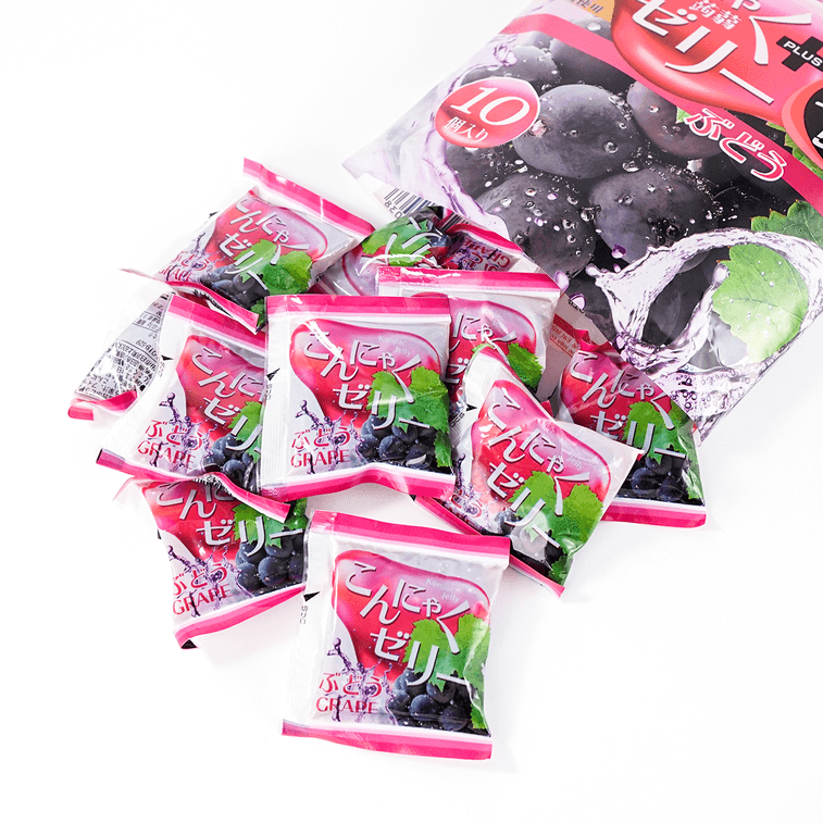 Portrait image of YUKIGUNI AGURI Fruit Jelly Grape Flavor pieces displayed outside the pouch, showing the individually wrapped jelly treats.